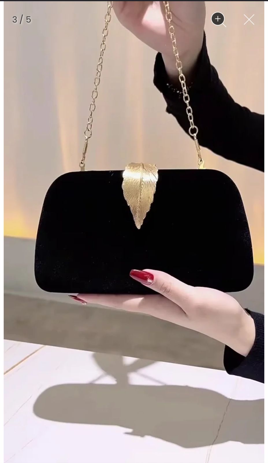 Black velvet clutch bag with gold chain strap