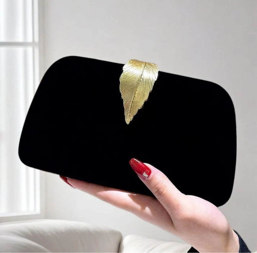 Black velvet clutch bag with gold leaf clasp and chain